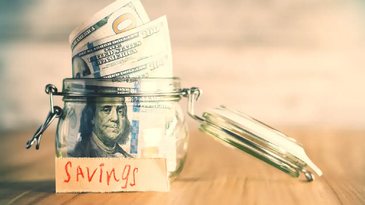money in jar labeled savings representing retirement savings and long term investing