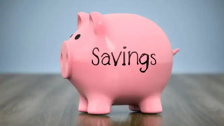 piggy bank labeled savings sitting on a desk representing a savings account