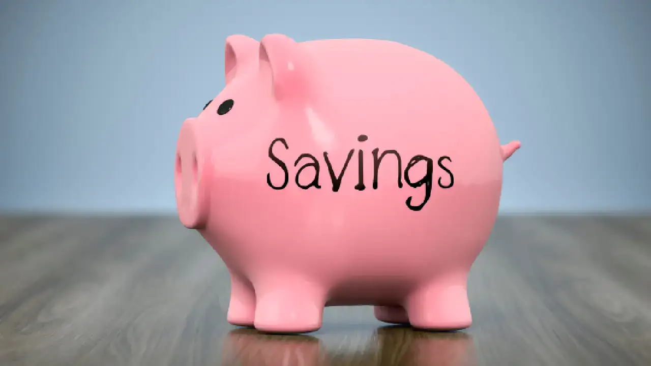piggy bank labeled savings sitting on a desk representing a savings account