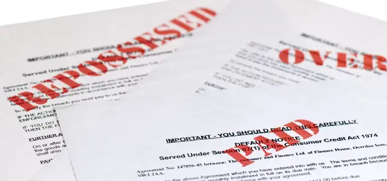overdue bills and financial notices representing living paycheck to paycheck