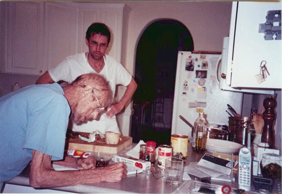 A father and son preparing a meal together in a kitchen