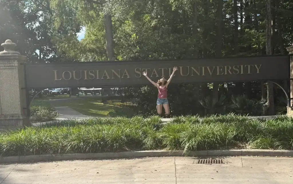 Daughter in front of LSU sign